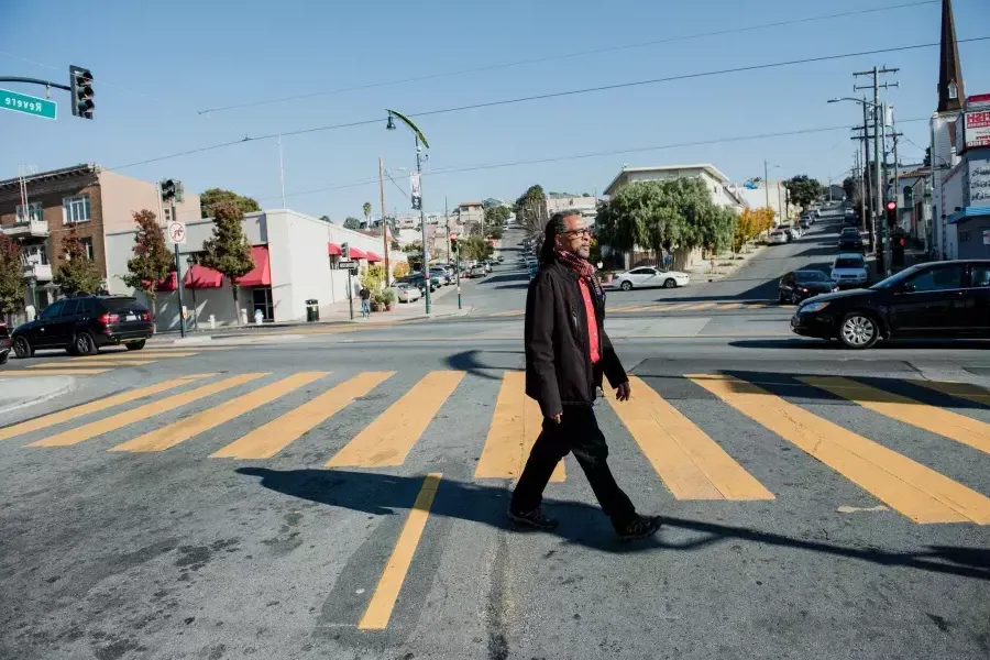 Ron Moultrie Saunders walking on the street.